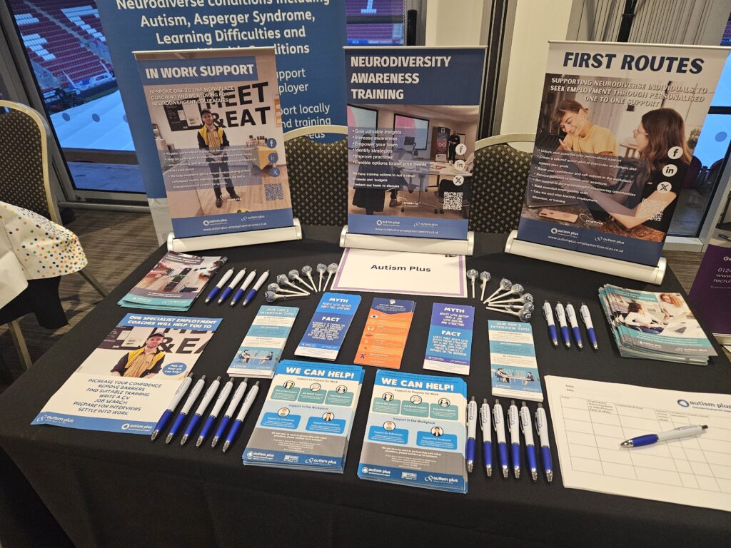 image of a table at an event with leaflets and pens on display